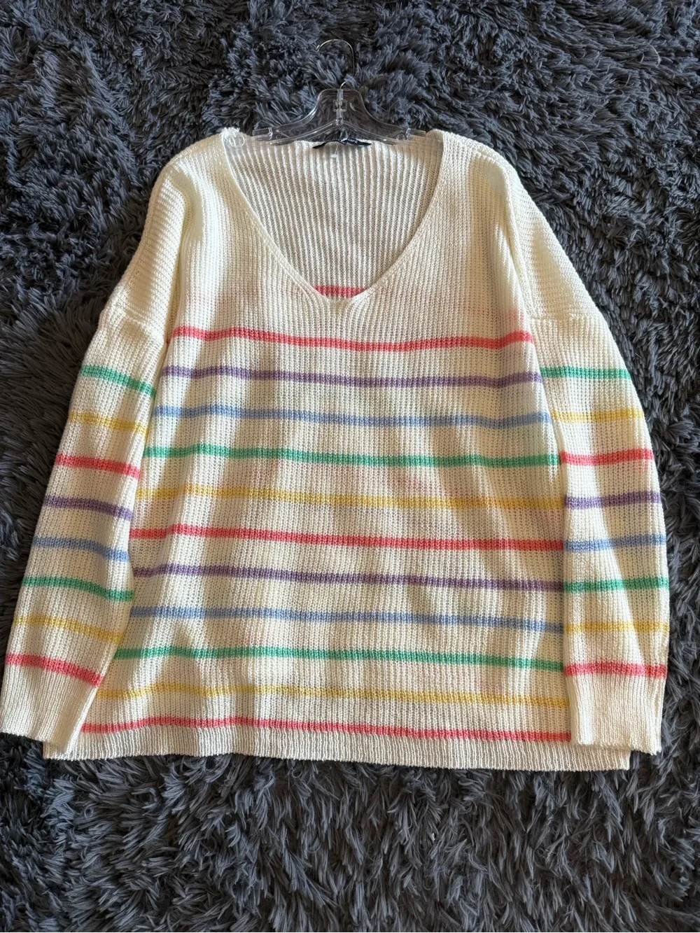 Cream V-Neck Sweater with Pastel Rainbow Stripes